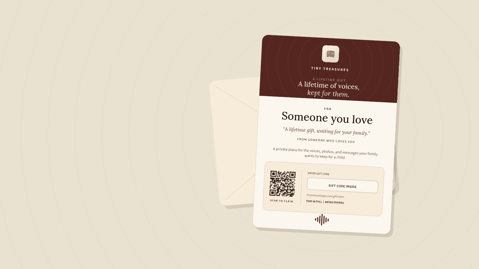 A printed Tiny Treasures gift card reading “A lifetime of voices, kept for them”, resting against its envelope.